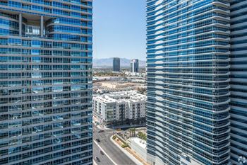 Two tall buildings with blue glass windows